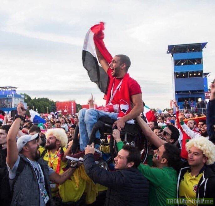 Mexican and Colombian fans lifting up an Egyptian fan in a wheelchair so he can watch his country play ⚽️❤️