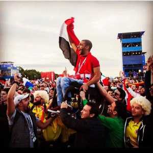 Mexicans & Colombians carrying an Egyptian fan so he gets the chance to watch his team play in the fan zone.