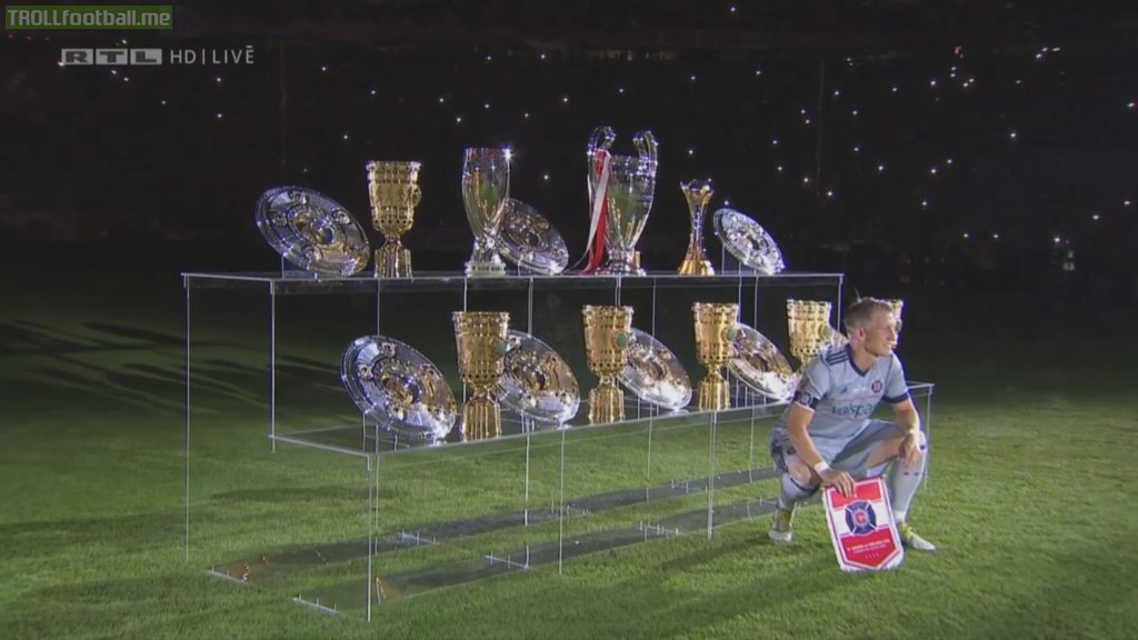 Bastian Schweinsteiger posing with all trophies he's won with Bayern
