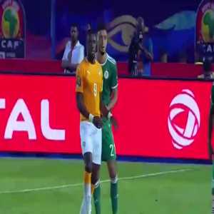 Algeria defender Ramy Bensebaini hits himself with Zaha's hand to try to win a foul