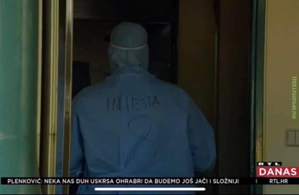 Medical worker in Croatia wears protective clothing with the name of his favourite player on the back.