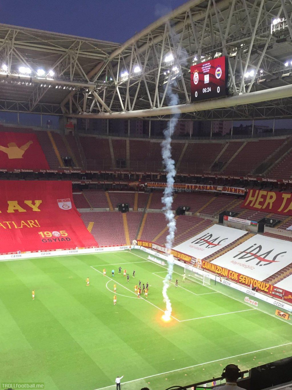 Stoppage in play during the Galatasaray-Fenerbahce match due to flares thrown onto the pitch. There are no fans in attendance. The flare came from the outside.
