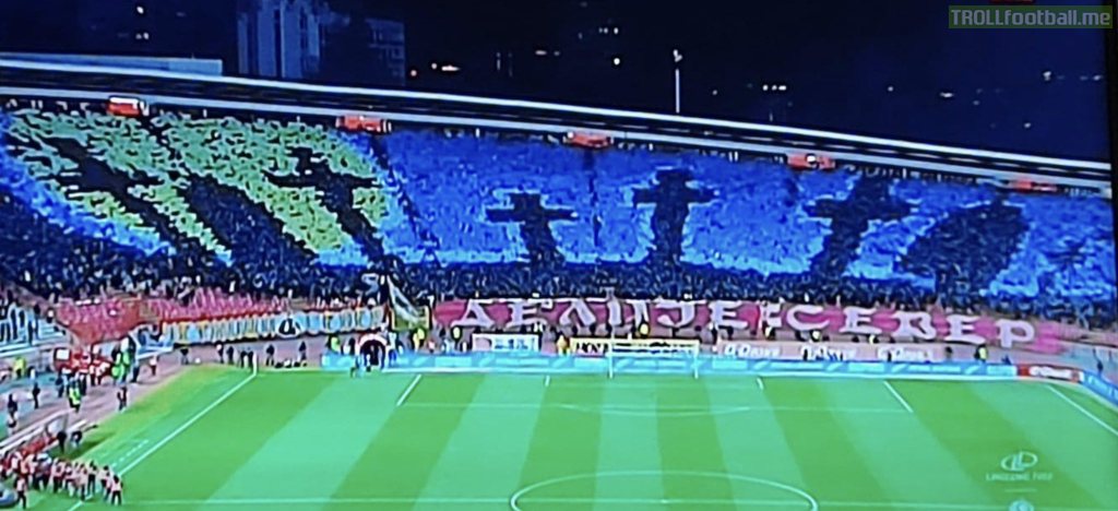 Red Star Belgrade fans showing their support for Russia - an Ukrainian flag over a cemetery