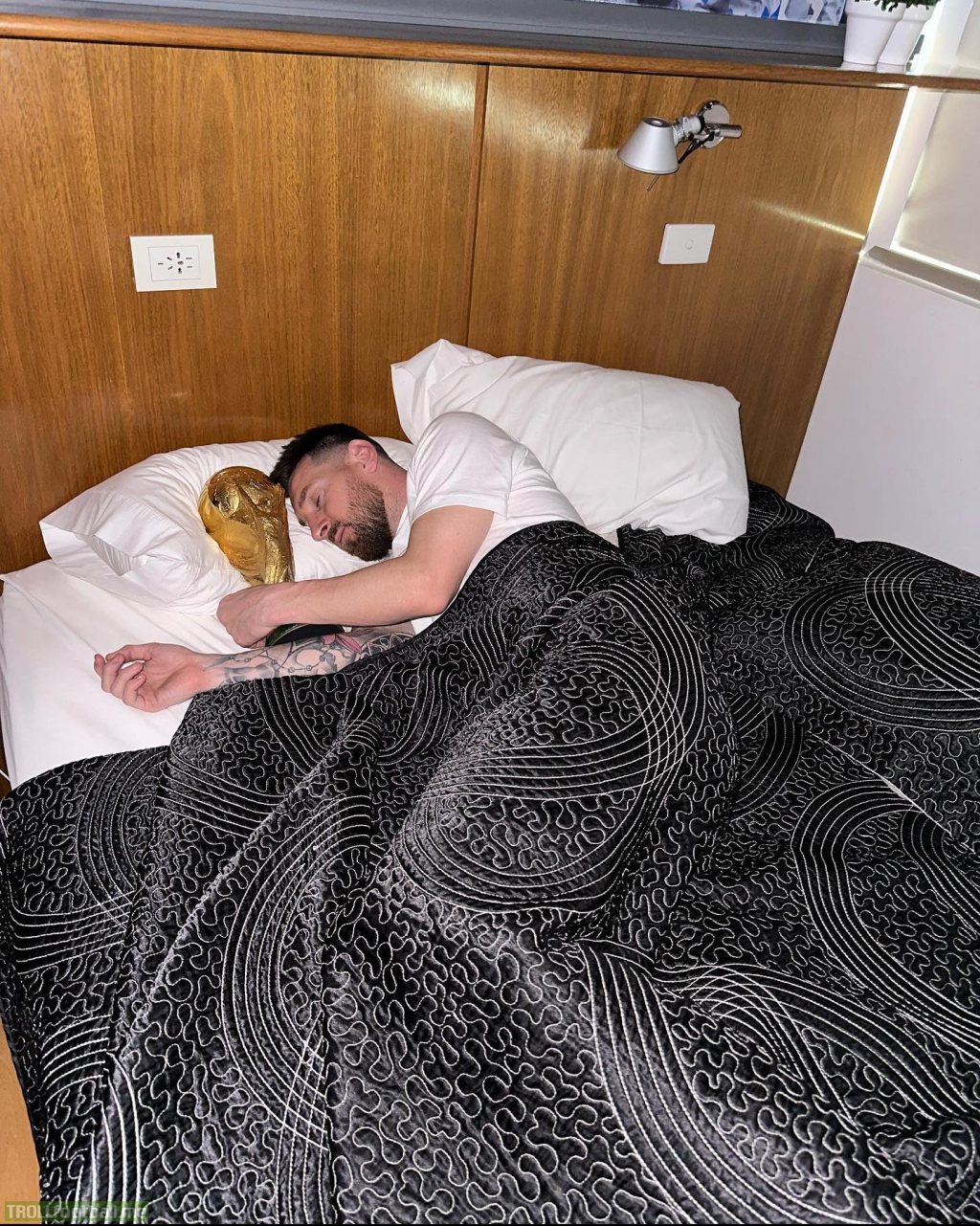 Messi sleeping with the World Cup trophy