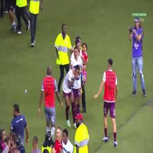 Internacional fan carrying a little girl runs onto the field and kicks a Caxias' player